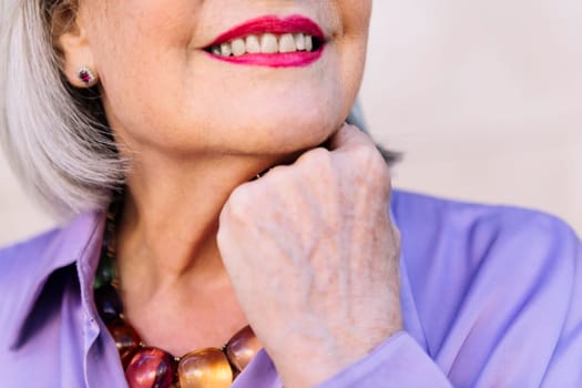 close up of an unrecognizable smiling senior woman, concept of happiness of elderly people and active lifestyle