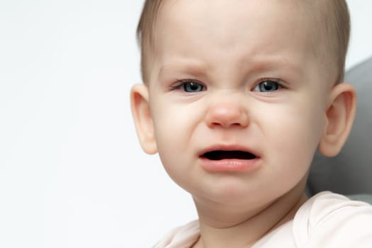 closeup of a baby crying, highlighting the urgent need for food and sleep.