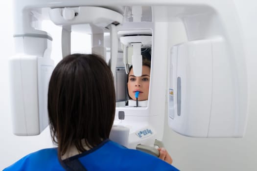 Close Up Portrait of Young Woman Undergoing Panoramic Teeth X-Ray at Dentists Office.