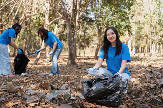 Volunteer collecting plastic trash in the forest. The concept of environmental conservation. Global environmental pollution. Cleaning the forest.