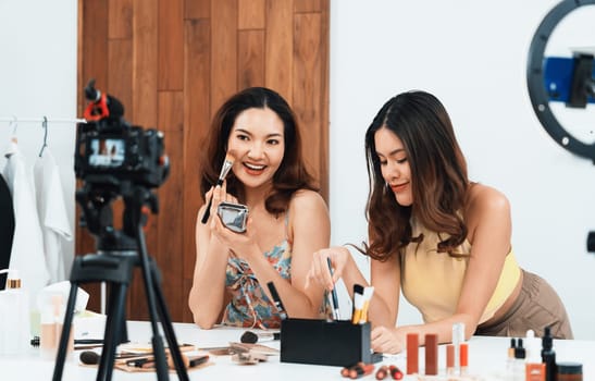 Woman influencer shoot live streaming vlog video review makeup uttermost social media or blog. Happy young girl with cosmetics studio lighting for marketing recording session broadcasting online.