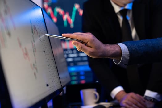 Stock traders pointing highest stock market on dynamic valued analysis on monitor real time screen, cooperating business investment in financial company to plan successful stock exchange. Sellable.