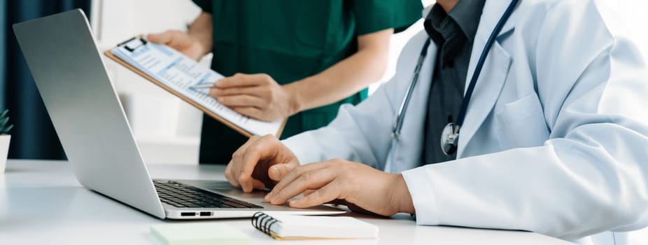 Professional various team of medical working and planning medical treatment at hospital table together. Teamwork lead to successful illness and sickness treatment. Panorama Rigid