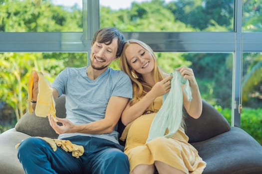 In a heartwarming scene, the future mom and dad hold their unborn baby's clothes in their hands, savoring the joy of anticipation and shared excitement for their little one's arrival.