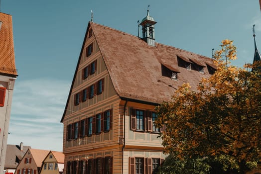 Old national German town house. Old Town is full of colorful and well preserved buildings. Baden-Wurttemberg is a state in southwest Germany bordering France and Switzerland. The Black Forest, known for its evergreen scenery and traditional villages, lies in the mountainous southwest. Stuttgart, the capital, is home to Wilhelma, a royal estate turned zoo and gardens. Porsche and Mercedes-Benz have headquarters and museums there. The 19th-century Hohenzollern Castle sits in the Swabian Alps to the south.