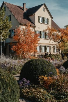 House with nice garden in fall. Flowers in the Park. Bietigheim-Bissingen. Germany, Europe. Autumn Park and house, nobody, bush and grenery