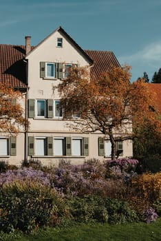 House with nice garden in fall. Flowers in the Park. Bietigheim-Bissingen. Germany, Europe. Autumn Park and house, nobody, bush and grenery