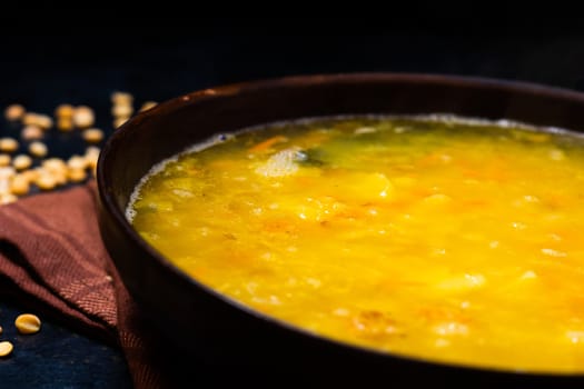 Homemade healthy vegetable soup with some bread and an onion