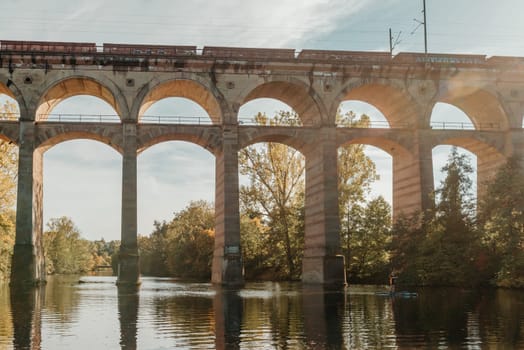 Railway Bridge with river in Bietigheim-Bissingen, Germany. Autumn. Railway viaduct over the Enz River, built in 1853 by Karl von Etzel on a sunny summer day. Bietigheim-Bissingen, Germany. Old viaduct in Bietigheim reflected in the river. Baden-Wurttemberg, Germany. Train passing a train bridge on a cloudy day in Germany