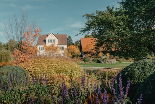 House with nice garden in fall. Flowers in the Park. Bietigheim-Bissingen. Germany, Europe. Autumn Park and house, nobody, bush and grenery