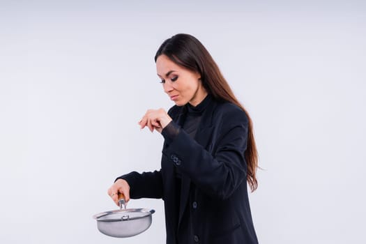 Happy young blonde woman sifts through sieve on red white bsckground in studio