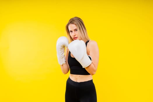 Smiling focused female boxer, concept of individual sport, active lifestyle, health and competition