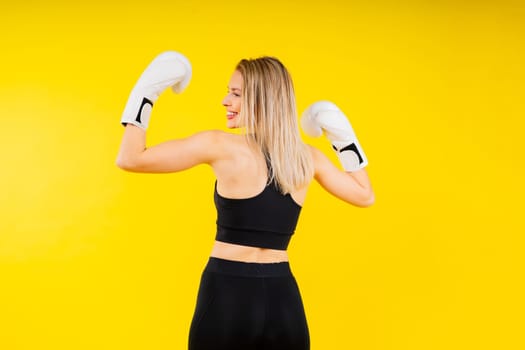 Smiling focused female boxer, concept of individual sport, active lifestyle, health and competition