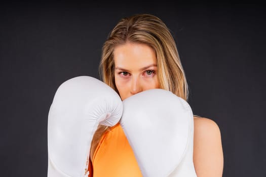 Smiling focused female boxer, concept of individual sport, active lifestyle, health and competition