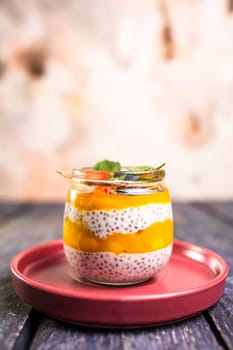 Chia seed pudding with mango, mixed berries, milk, Greek yogurt, assorted fruit, and honey. Tropical-inspired delight for a refreshing summer treat.