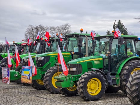 Wroclaw, Poland, February 15, 2024: Farmers protest against the European Union's anti-agricultural policies. Several farm tractors are parked under a cloudy sky