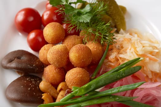 Tasty appetizer. Cheese balls and pickled vegetables