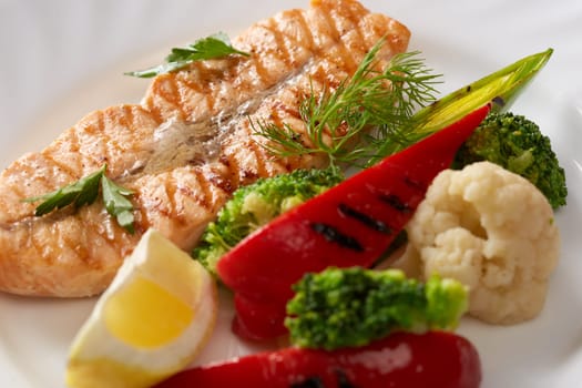 Studio shot of grilled fish and steamed vegetables