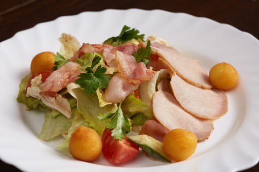 Image of meat slicing, vegetable salad and cheese balls