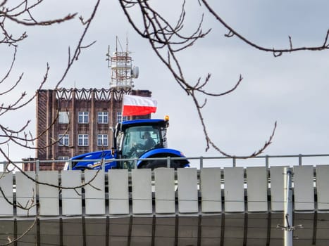 Wroclaw, Poland, February 15, 2024: Protesting farmer on an overpass. Farmers' strike in front of the voivodeship office in the city center