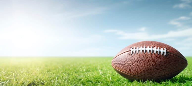 An American football placed on a green grass field with a bright and sunny sky in the background, symbolizing sports and outdoor activities.