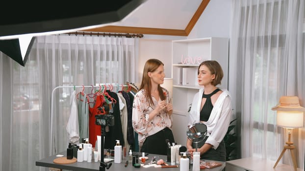 Two influencer partner shoot live streaming vlog video review makeup prim social media or blog. Happy young girl with cosmetics studio lighting for marketing recording session broadcasting online.