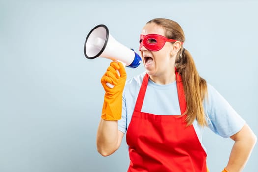 Woman with Megaphone Wearing Red Apron and Superhero Eye Mask.