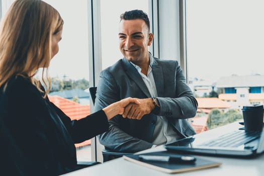 Businessman executive handshake with businesswoman worker in modern workplace office. People corporate business deals concept. uds