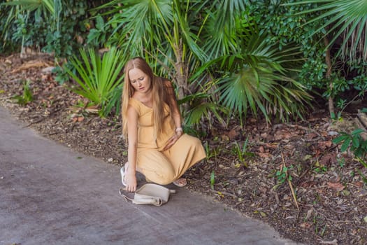 pregnant woman drops her keys and struggles to pick them up, highlighting the physical limitations that can arise during pregnancy. Patience and support become essential.