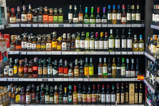 Shop window with alcoholic drinks. Many alcoholic beverages on the shelves in the store. 2023.07.20 Vinnytsia, Ukraine