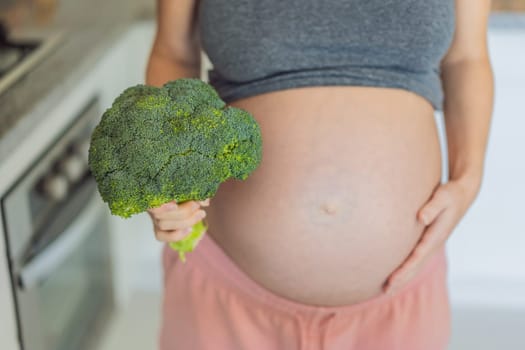 Embracing a nutrient-rich choice, a pregnant woman eagerly prepares to enjoy a wholesome serving of broccoli, prioritizing healthy and nourishing options during her pregnancy.