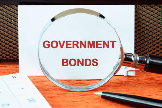 Government Bonds text on a white card through a magnifying glass