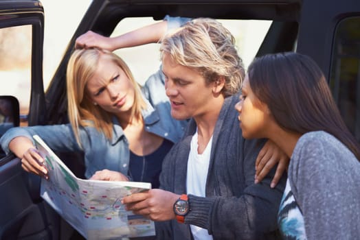 Group of friends, outdoor and map for adventure, travel and lost with journey and getaway trip. Lost, man and women with paper and searching for a place with conversation and discussion with vehicle.