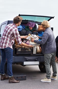 Men, friends and luggage in car trunk on road trip or camping outdoor for holiday, vacation or adventure. Male people, bags and unpacking boot or transportation together in Europe, journey or travel.