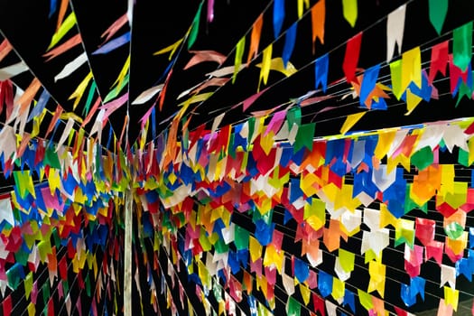 Colorful paper flags adorn a celebratory event, adding a festive touch.