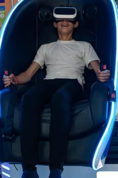 A guy is sitting on a ride with vr glasses, 5d and adrenaline from virtual reality.