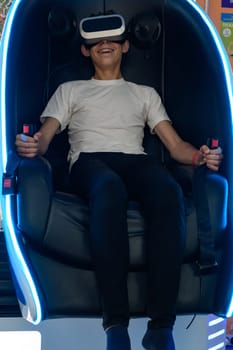 A guy is sitting on a ride with vr glasses, 5d and adrenaline from virtual reality.
