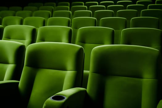 Empty green seats in cinema, domestic intimacy, zoom in, up close. Neural network generated in January 2024. Not based on any actual scene or pattern.