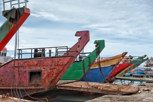 colorful rugged Ship prow on cloudy sky background