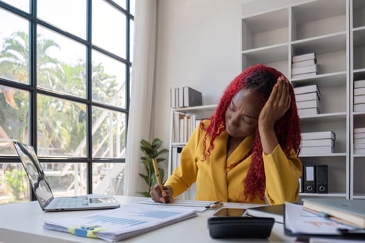 African American businesswoman is tired from working in the office..