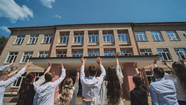 Graduates say goodbye to the school and wave goodbye