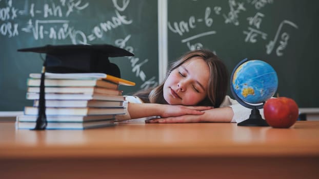 A cheerful schoolgirl plays with emotions on camera against the backdrop of school objects and falls asleep