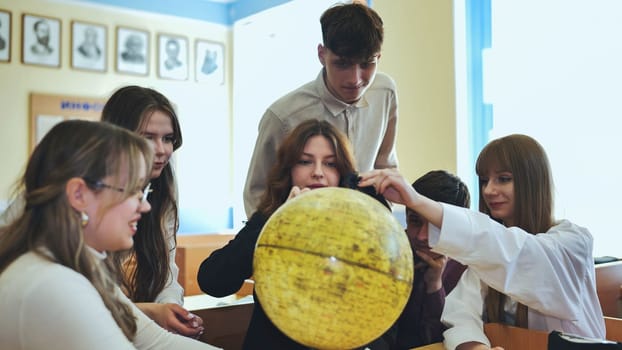High school students looking at the yellow globe of the moon
