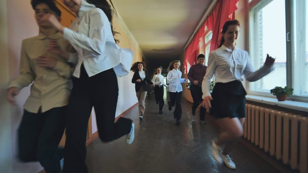 The students are running down the hallway of the school