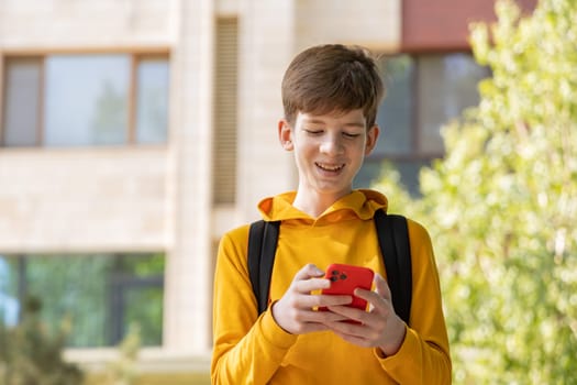 A young boy is having a video call, holding a smartphone in his hands