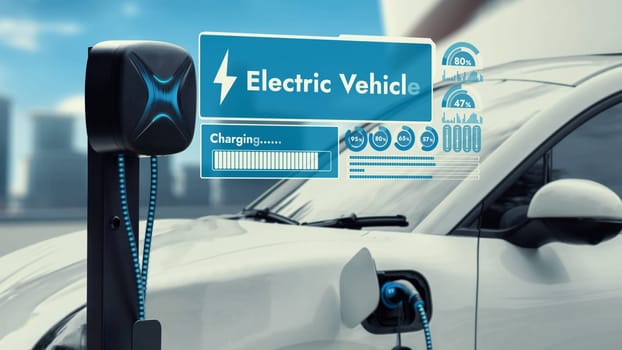 Electric car plug in with charging station to recharge battery display smart digital battery status hologram by EV charger cable on cityscape background. Future innovative energy sustainability.Peruse