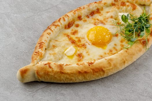 khachapuri in Adjarian style on a stone background studio food photo 3
