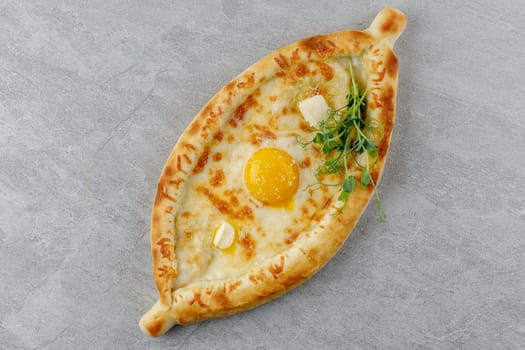 khachapuri in Adjarian style on a stone background studio food photo 2