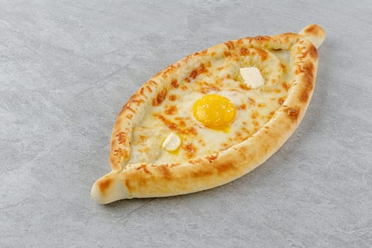 khachapuri in Adjarian style on a stone background studio food photo