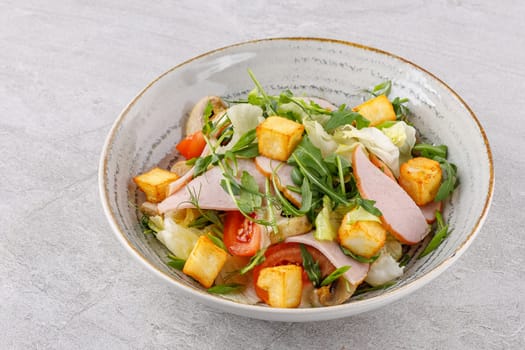 salad with ham and halloumi cheese on a stone background studio food photo 5